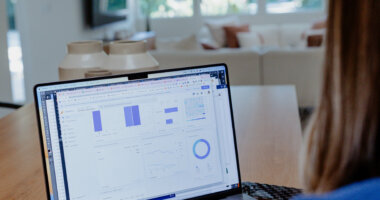 woman designing an industry trends report on a laptop