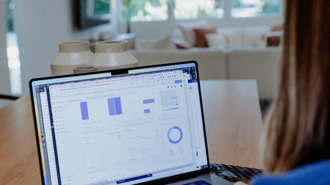 woman designing an industry trends report on a laptop